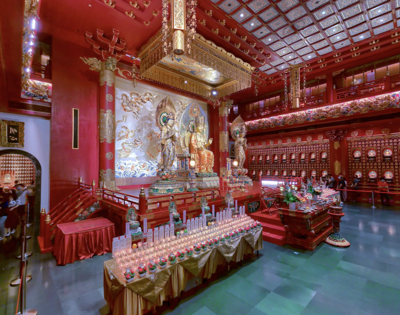 Buddha statues and rows of offerings inside the Buddha Tooth Relic Temple