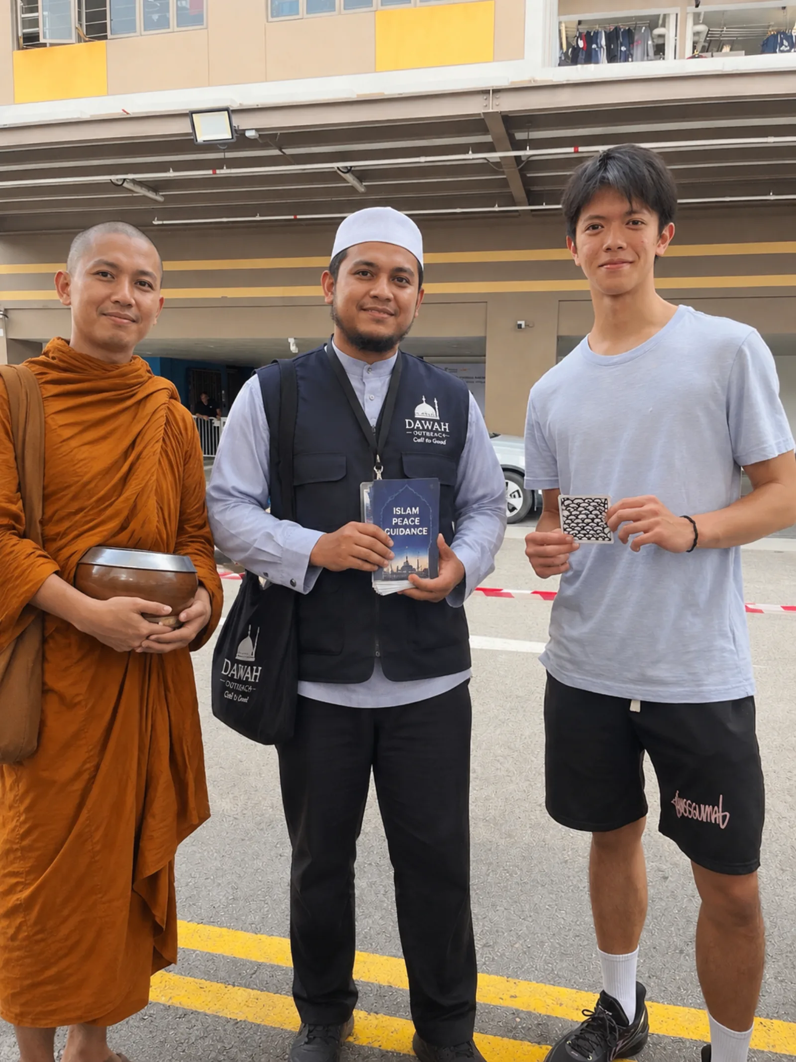 On Mosque Street: Douglas Chiong with a Buddhist monk and a Dawah officer